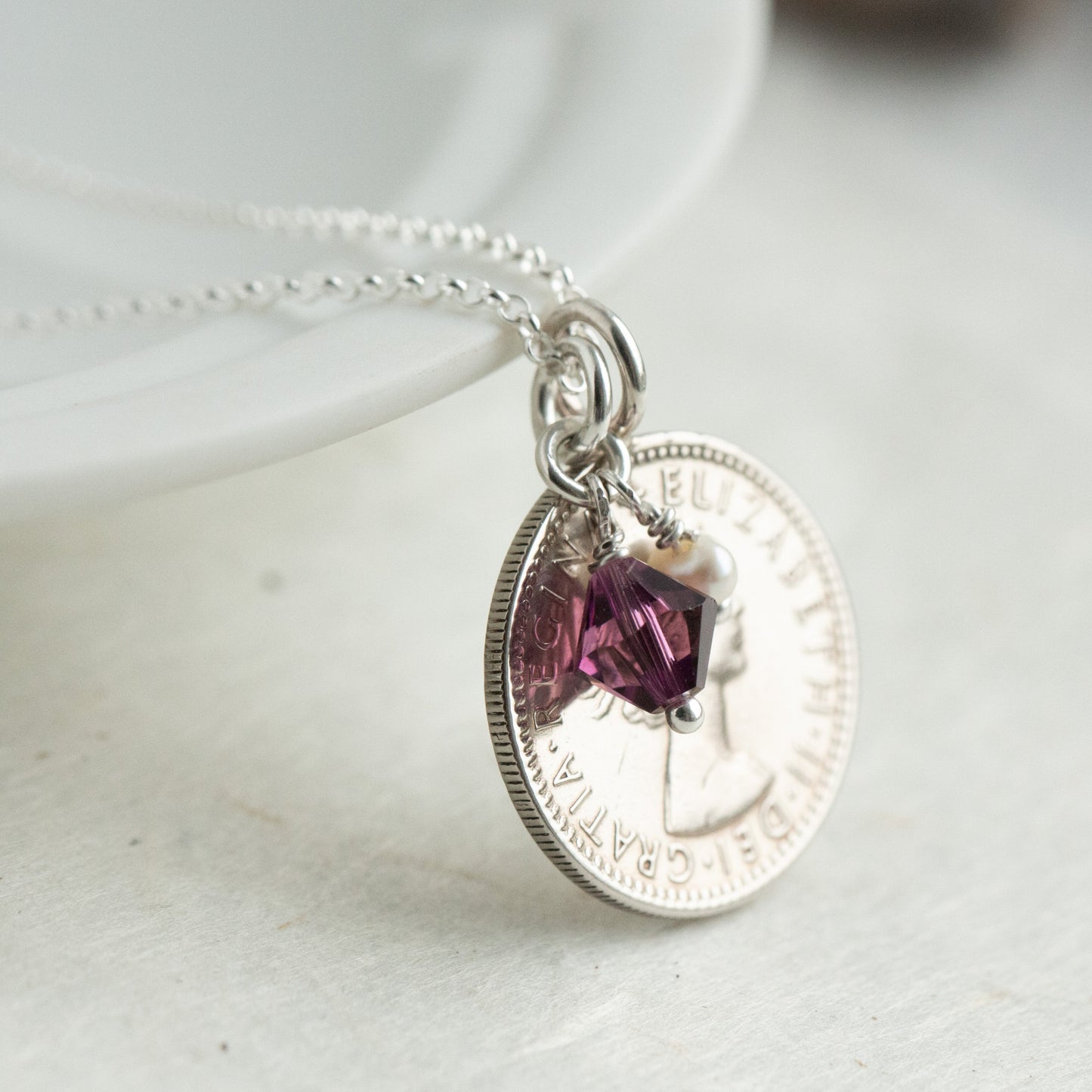 1955 Queen Elizabeth II sixpence pendant with February birthstone charm necklace.