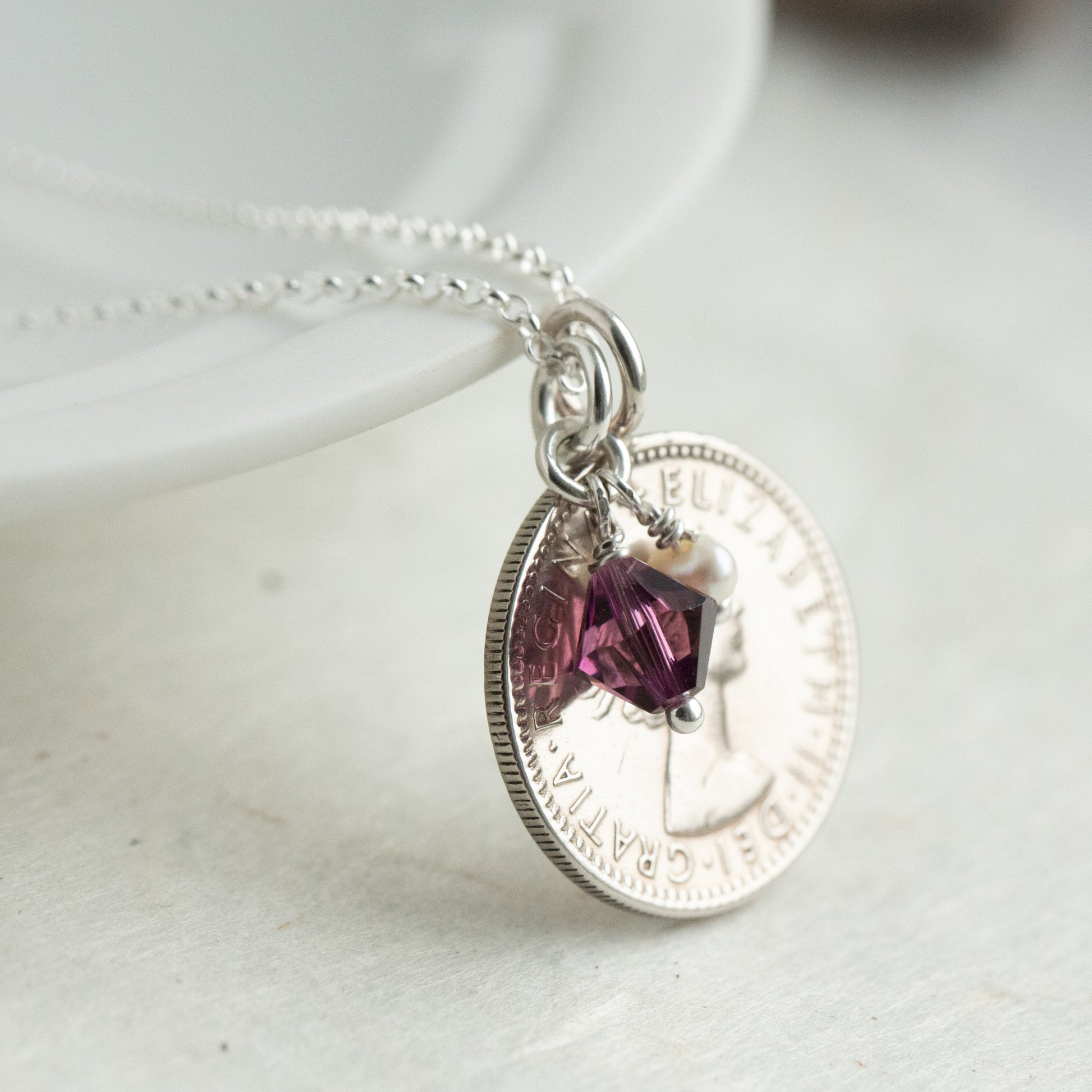 1955 Queen Elizabeth II sixpence pendant with February birthstone charm necklace.