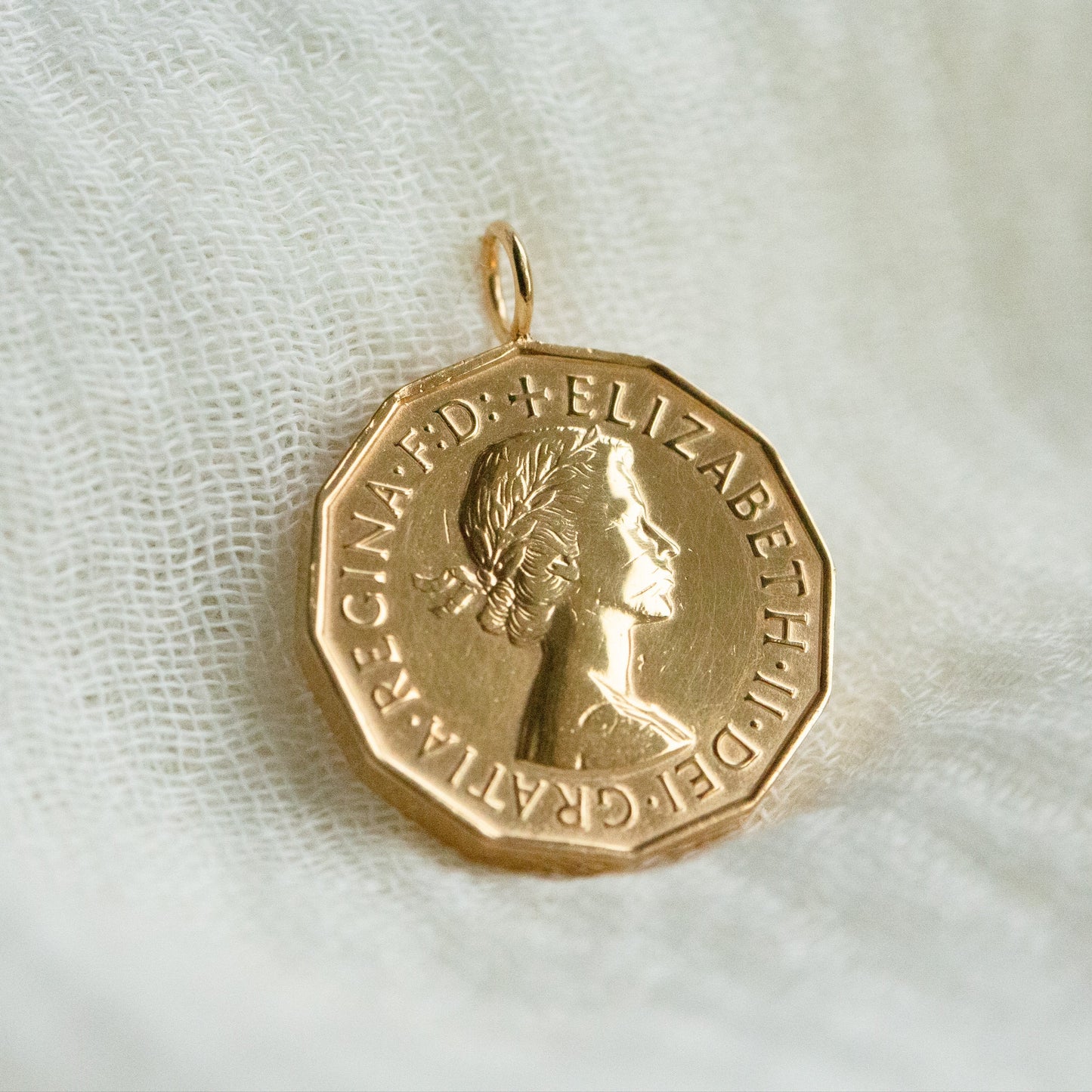 Gold coin pendant with a Queen Elizabeth on a white fabric background - gold coins and coin jewellery handcrafted by Prenoa