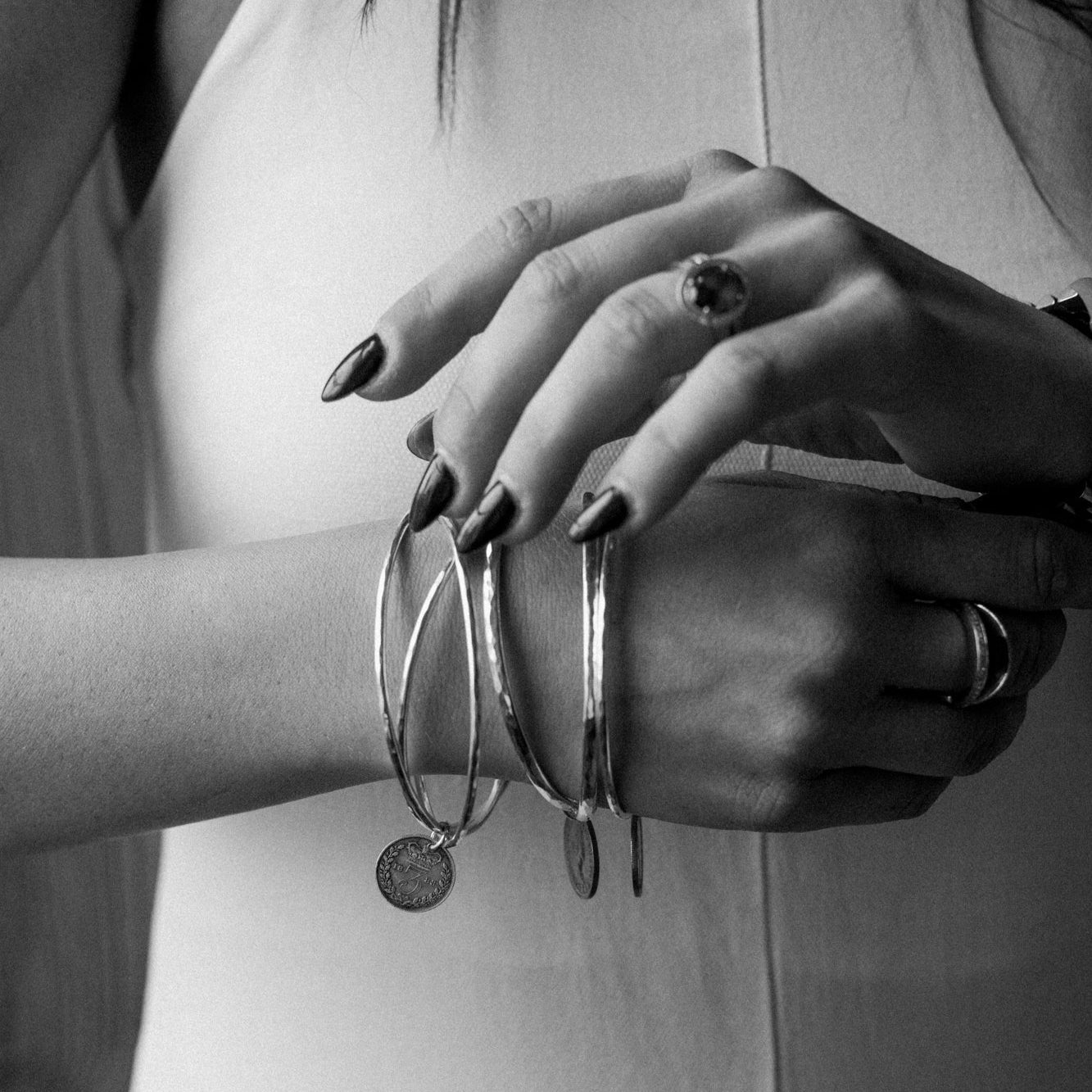 Stacked sterling silver coin bangles