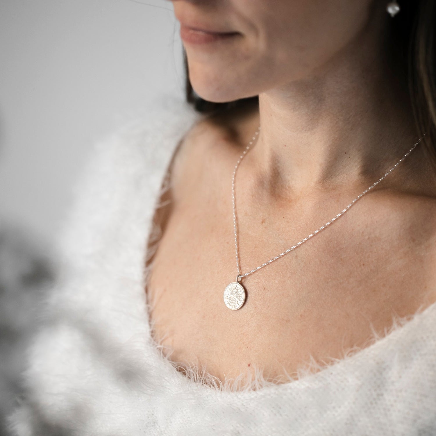 Prenoa model wears a silver acorns threepence coin pendant on a sterling silver chain, with a white jumper. Model is 5ft4in and wears an 18inch chain. 