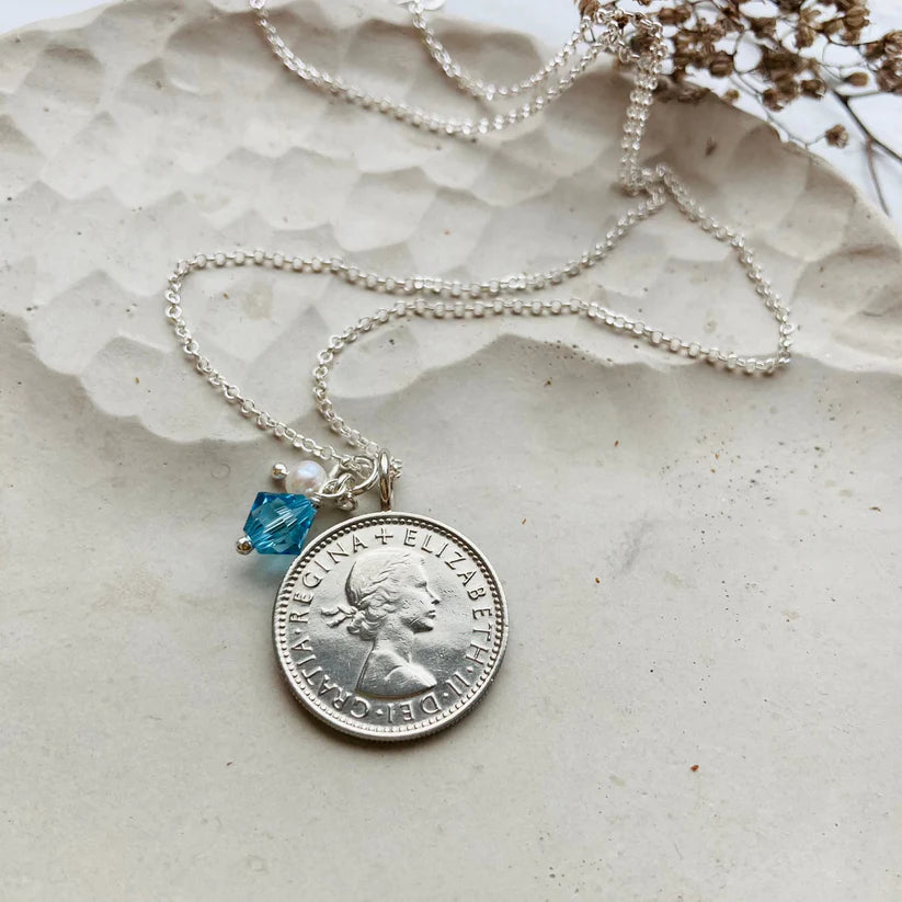 Elegant aquamarine birthstone with 1964 sixpence and sterling silver chain