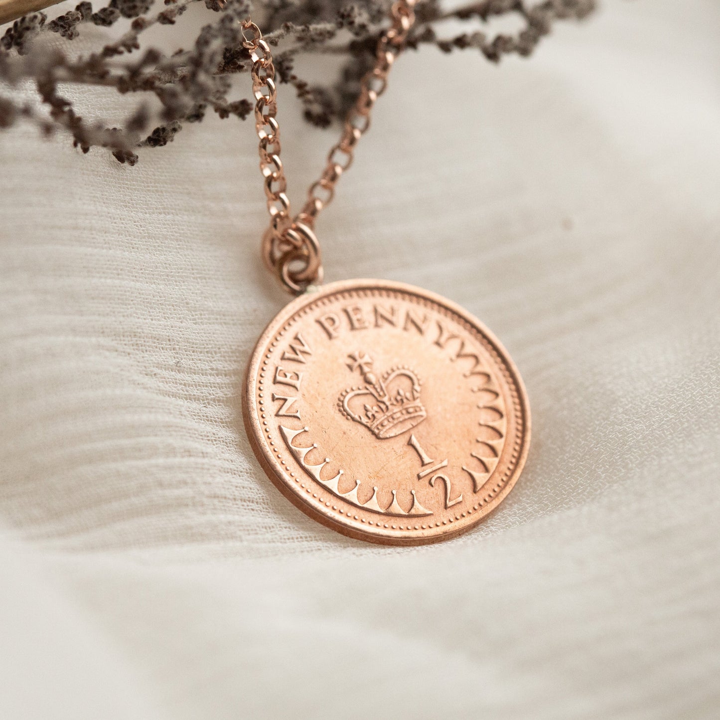 Bronze half penny coin with rose gold bail pendant. 