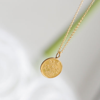 22ct Gold plated real Norwegian coin necklace with a round pendant on a light background