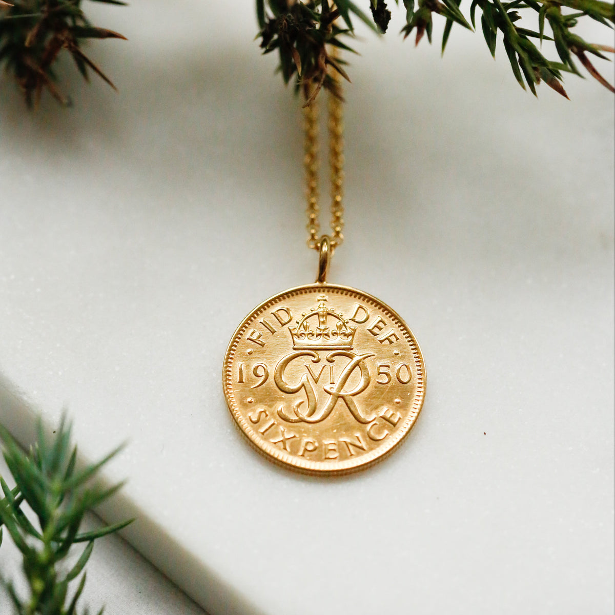 Festive Christmas gold 1950 British sixpence coin necklace with evergreen foliage