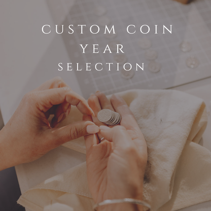 Person holding coins with text 'Custom Coin Year Selection' on a blurred background. Choose your specific year and make your gift extra special