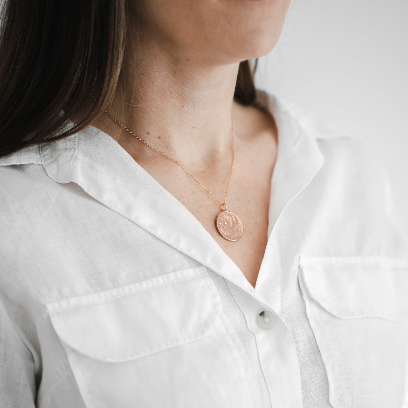 Rebecca wears an Italian bee coin necklace with a rose gold vermeil chain at 18inches in length. The perfect copper coin gift for her with rose gold. 