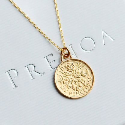 Gold sixpence coin 1966 dated necklace on a white box with flowers around
