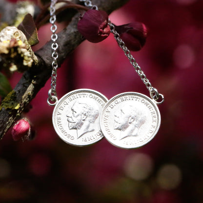 Two real George V 1930's threepence coins, soldered together to make this unique double coin necklace. The necklace hangs, heads' side out from a cherry blossom branch and catches the light with the portrait facing left.