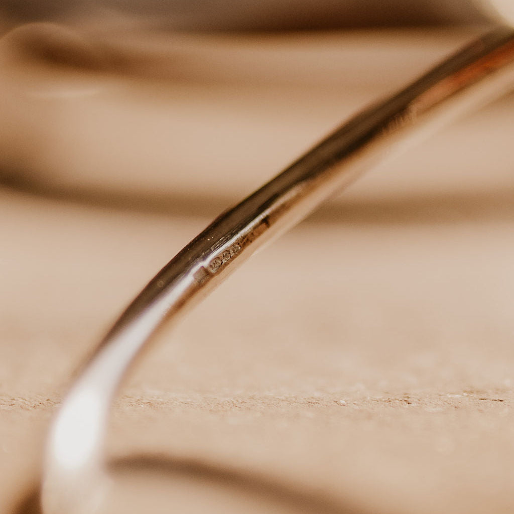 Close-up of a sterling silver hallmarked bangle.