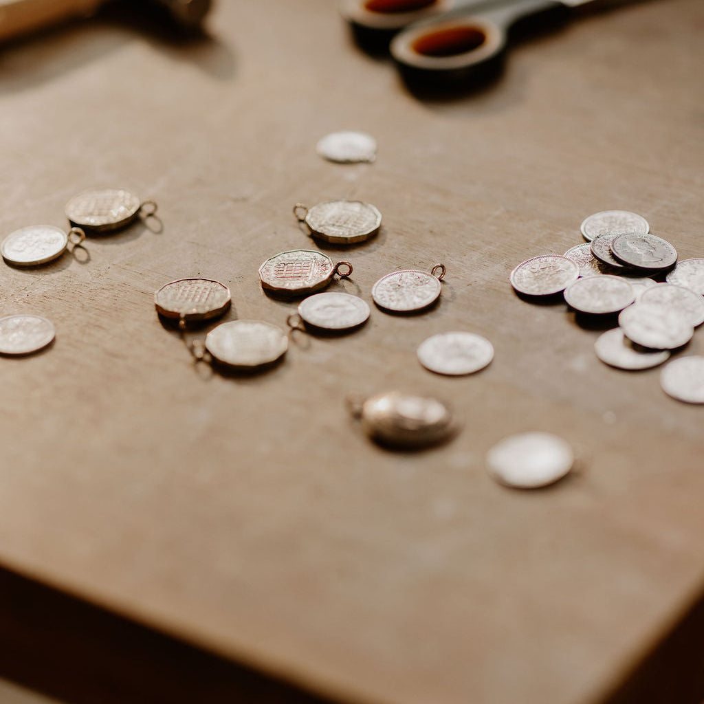 Jewelry-making tools and components on a wooden surface