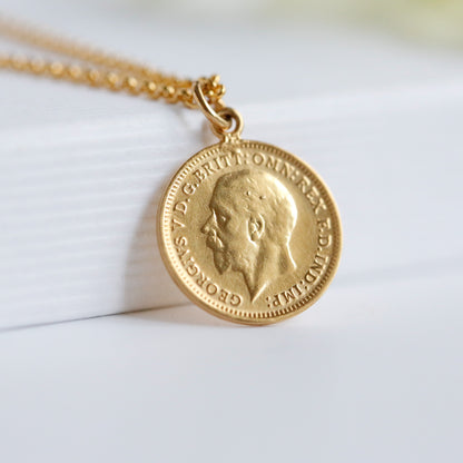 George V real British coin necklace with 22 carat gold plating and gold chain, sits on a white background
