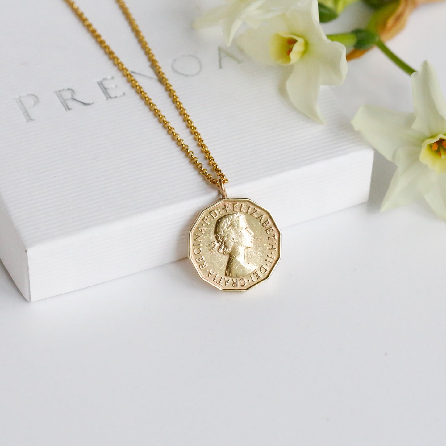 British threepence gold coin pendant necklace with vermeil chain featuring Elizabeth II. White box and white background.