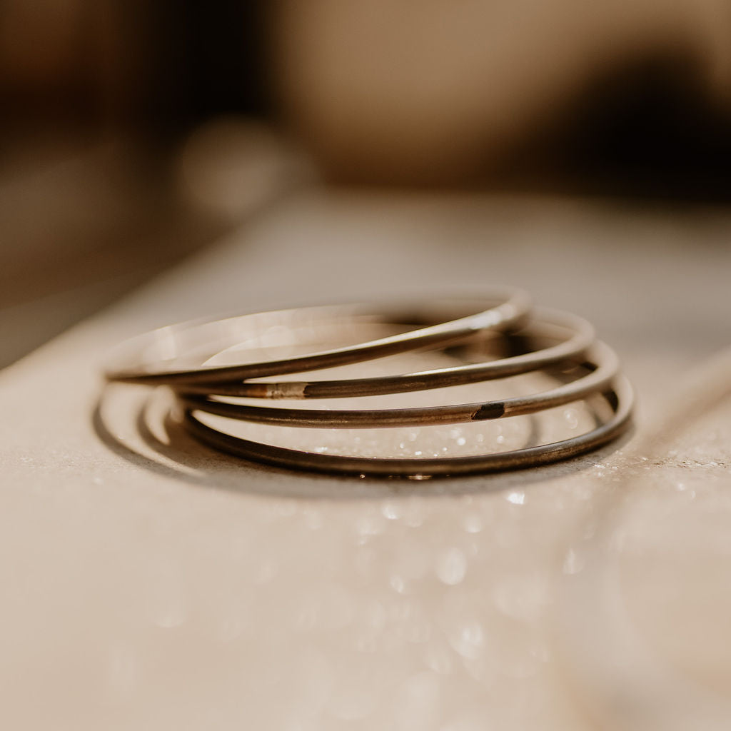 Four sterling silver bangles, soldered and flat, ready for cleaning.
