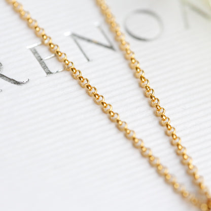 Gold chain necklace on a blurred background with text