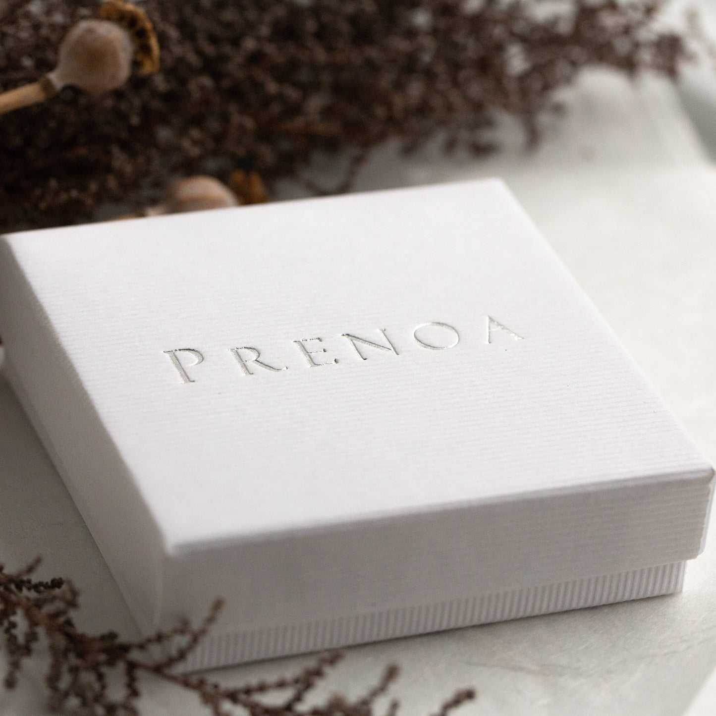 Prenoa hand wraps all items in our linen finish gift boxes.