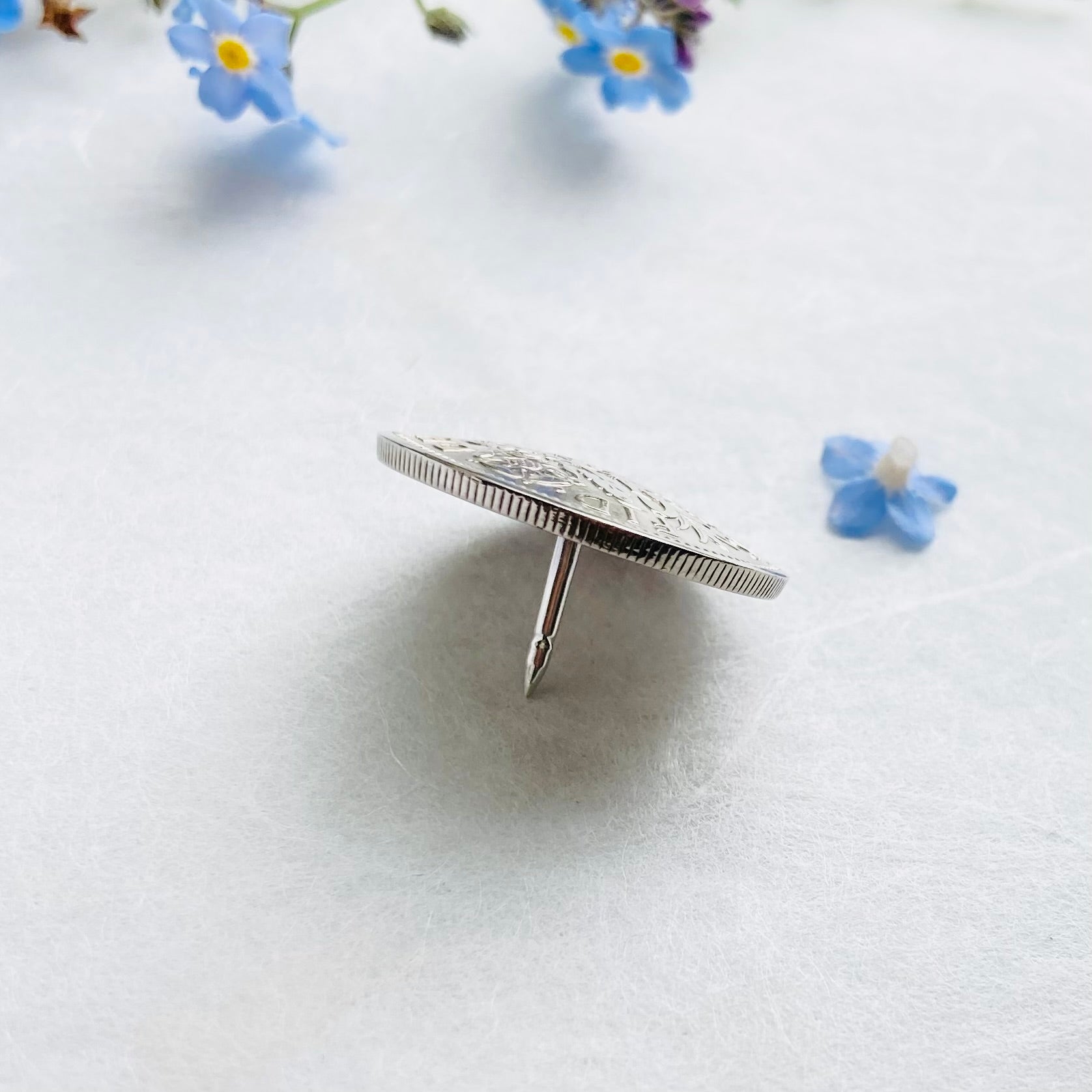 Side view of sixpence brooch pin