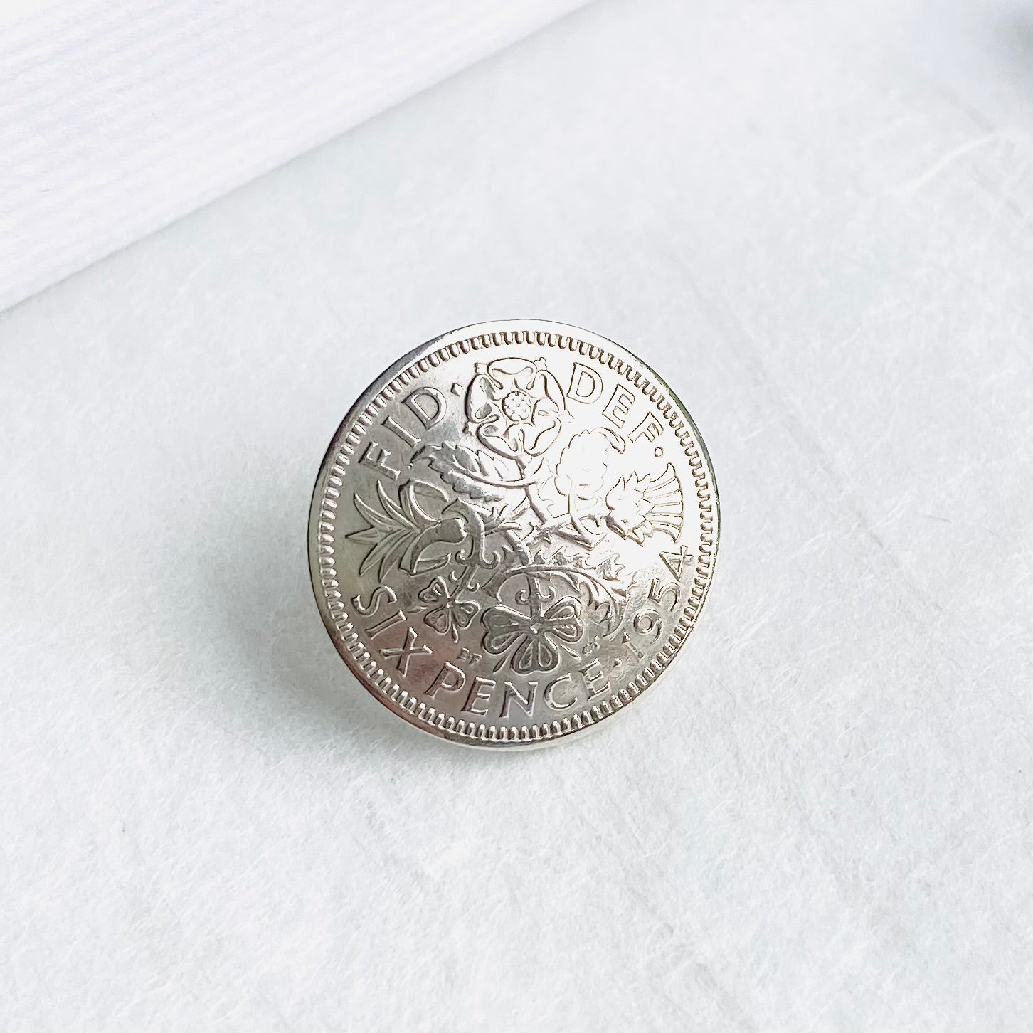 domed silver British sixpence pin