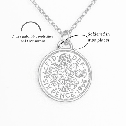 Silver pendant necklace with detailed design on a white background