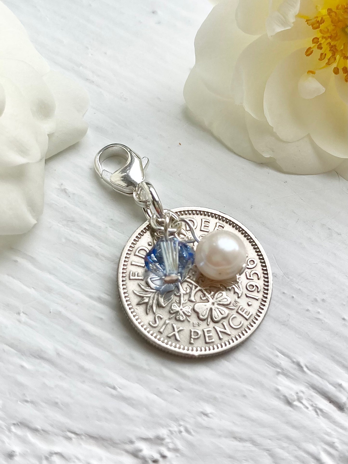 Sixpence British coin with light sapphire crystal and pearl charm. Something old, new, borrowed and blue and a sixpence for her shoe.