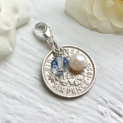 Sixpence British coin with light sapphire crystal and pearl charm. Something old, new, borrowed and blue and a sixpence for her shoe.